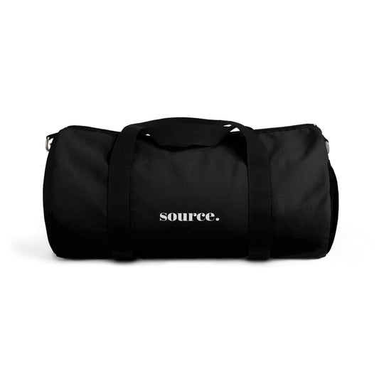 Black duffel bag with 'source.' text on a white background