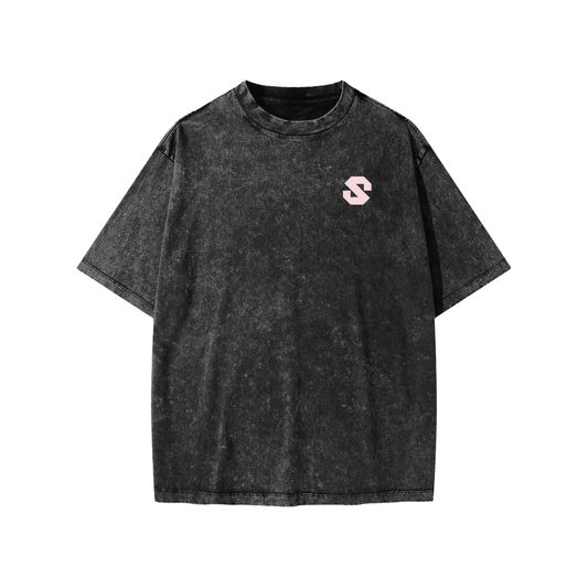 Black t-shirt with a small pink logo on a white background