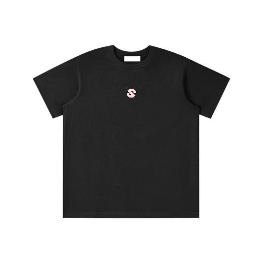Black t-shirt with a small pink logo on a white background